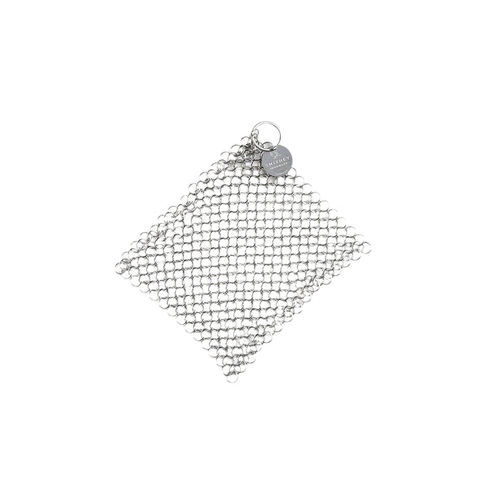 Smithey Ironware Chainmail Scrubber for cleaning cast iron cookware, featuring stainless steel links for effective scrubbing.