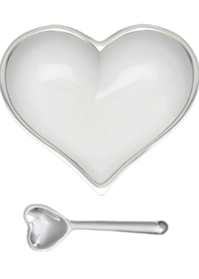The Inspired Generations Happy Heart Snack Bowl & Spoon features a white, heart-shaped dish and matching spoon with shiny silver accents—perfect for showcasing your Happy Hearts Bowls collection.