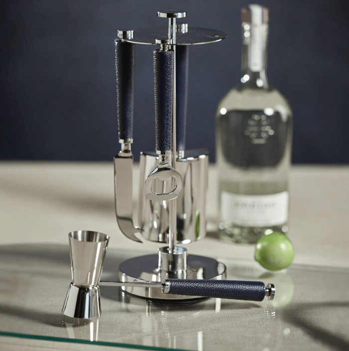 The Zodax Laguna Tool Bar Set, featuring metal and dark handles, stands on a counter with a jigger, clear liquor bottle, and lime in the background.