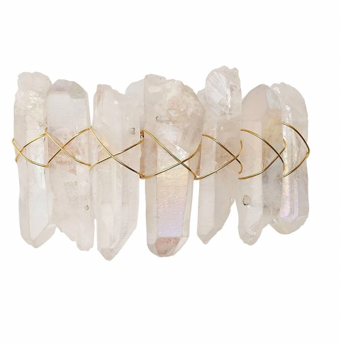 The Kim Seybert Radiant Napkin Ring Iridescent Set of 4 features clear crystal points arranged side by side and wrapped in thin gold wire in a crisscross pattern, reminiscent of rock crystal, against a plain white background.