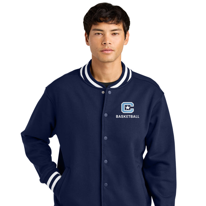 Person wearing a navy blue jacket with a basketball logo on a white background